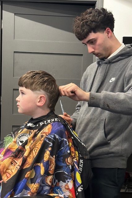 Father and son haircut moment